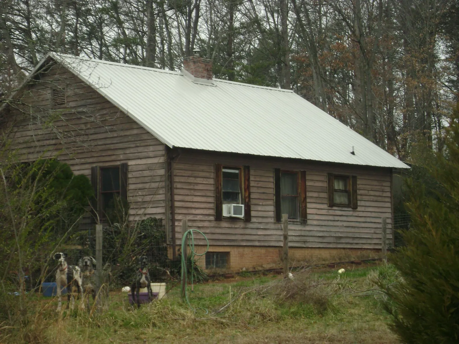 White metal roof on an old wood sided farmhouse, from a Asphalt Shingle Roof Repair job in Bedford